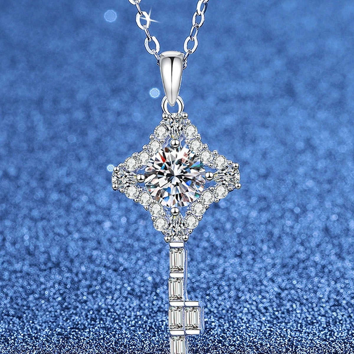 Ornate Key Moissanite Pendant Necklace with Cubic Zirconia in Platinum-Plated S925 Sterling Silver blue background angled view