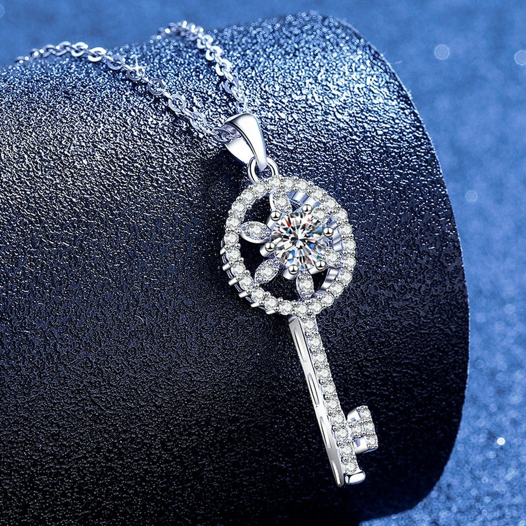 Round Key Moissanite Pendant Necklace with Cubic Zirconia in Platinum-Plated S925 Sterling Silver blue background angled view
