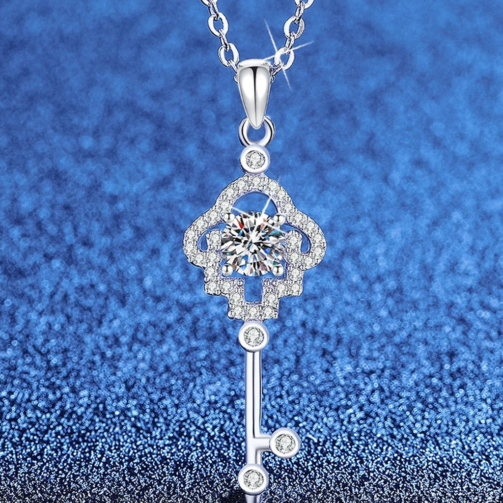 Cross Key Moissanite Pendant Necklace with Cubic Zirconia in Platinum-Plated S925 Sterling Silver blue background angled view
