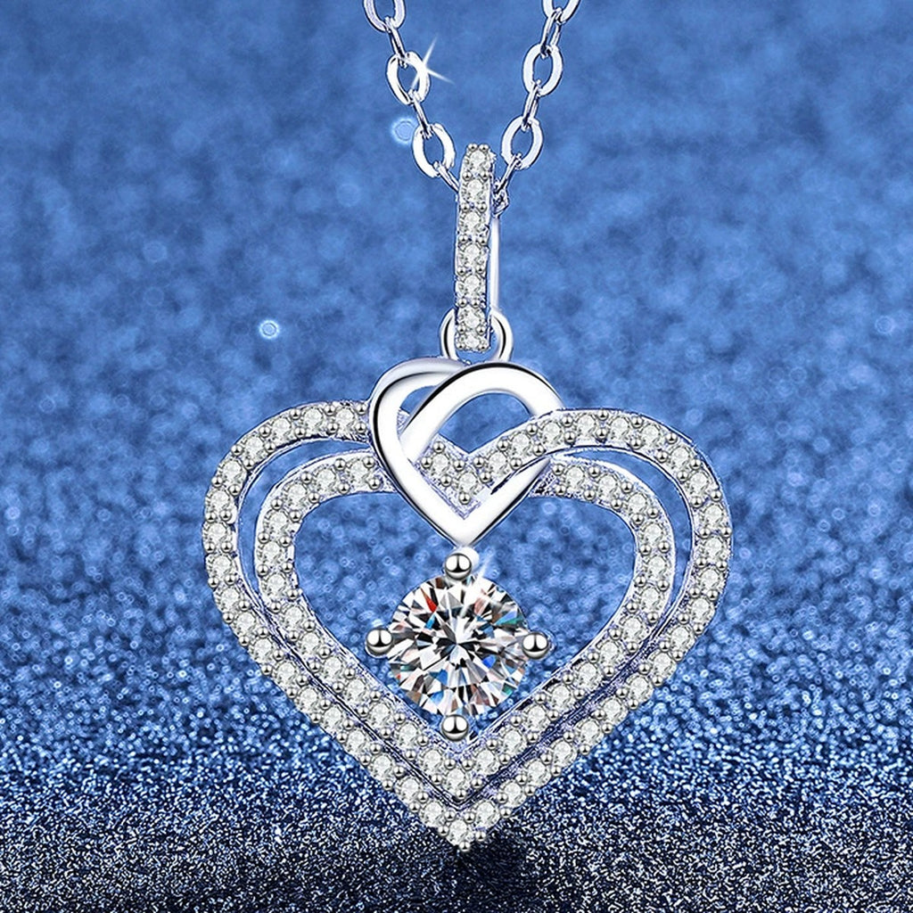 Heart Moissanite Pendant Necklace with Cubic Zirconia in White Gold-Plated S925 Sterling Silver blue background angled view