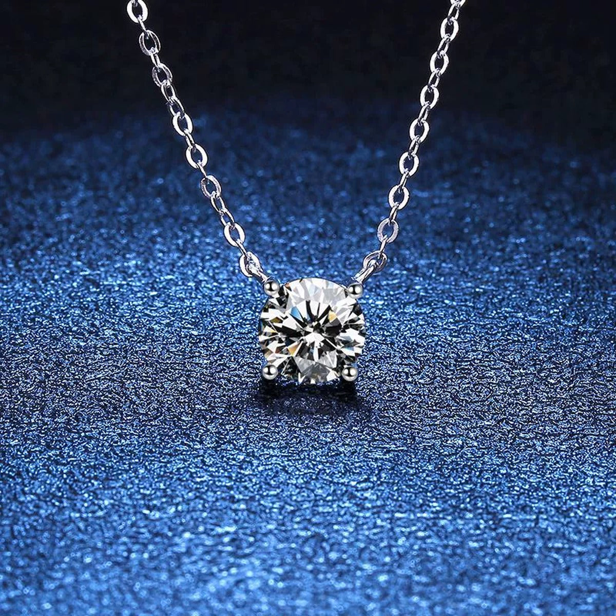 Round Moissanite Pendant Necklace in S925 Sterling Silver blue background angled view