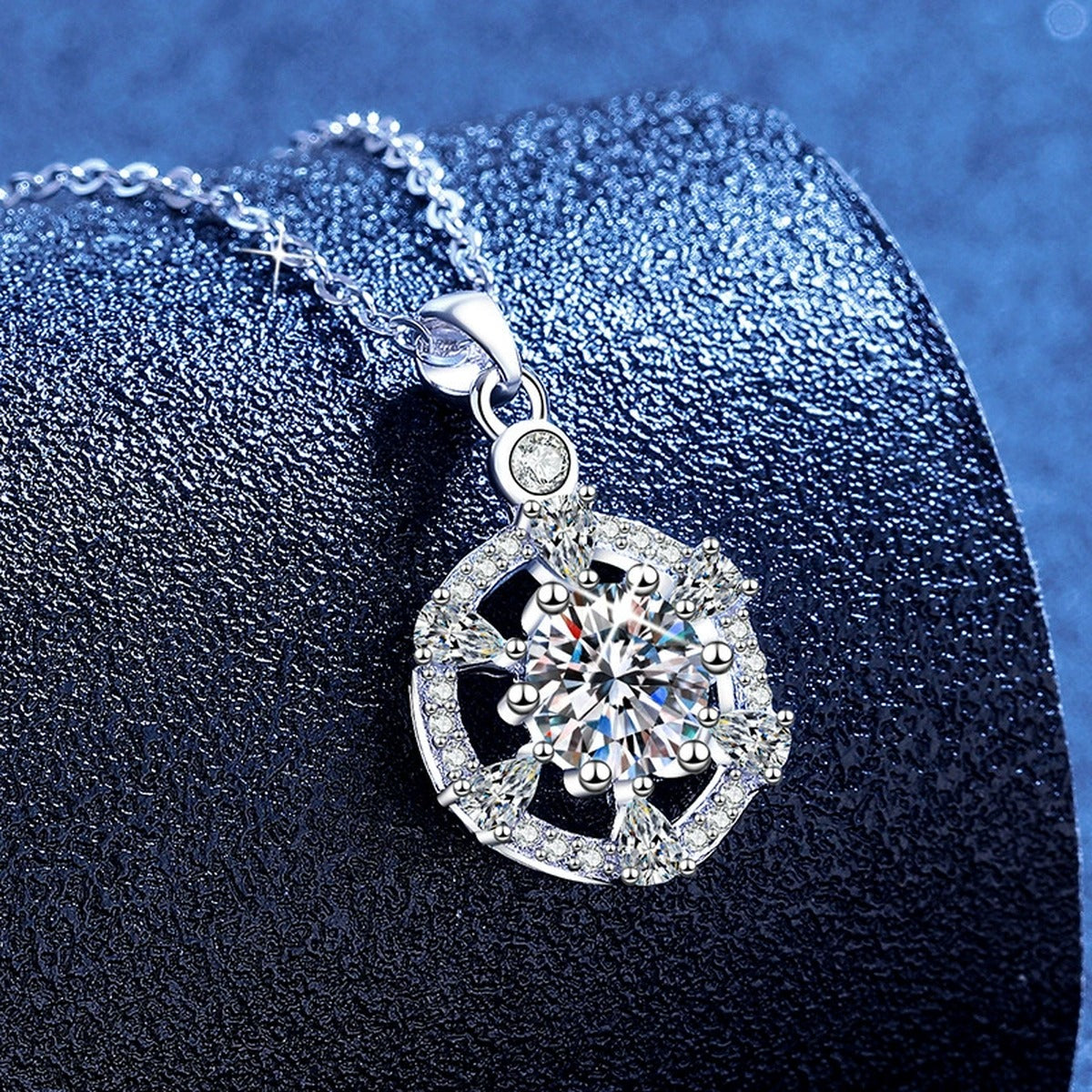 Round Halo Moissanite Pendant Necklace with Cubic Zirconia in White Gold-Plated S925 Sterling Silver blue background angled view