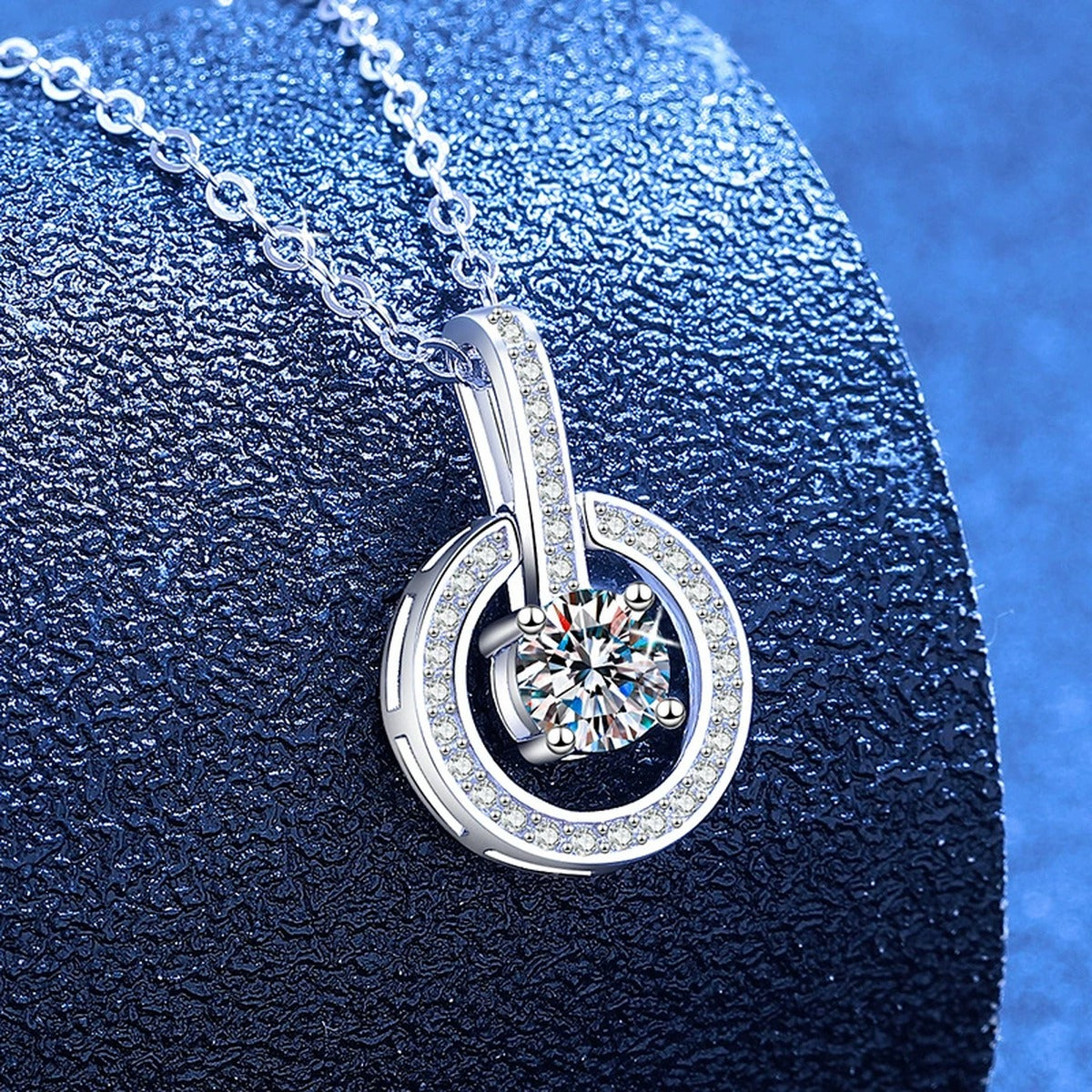 Round Moissanite Pendant Necklace with Cubic Zirconia in White Gold-Plated S925 Sterling Silver blue background angled view