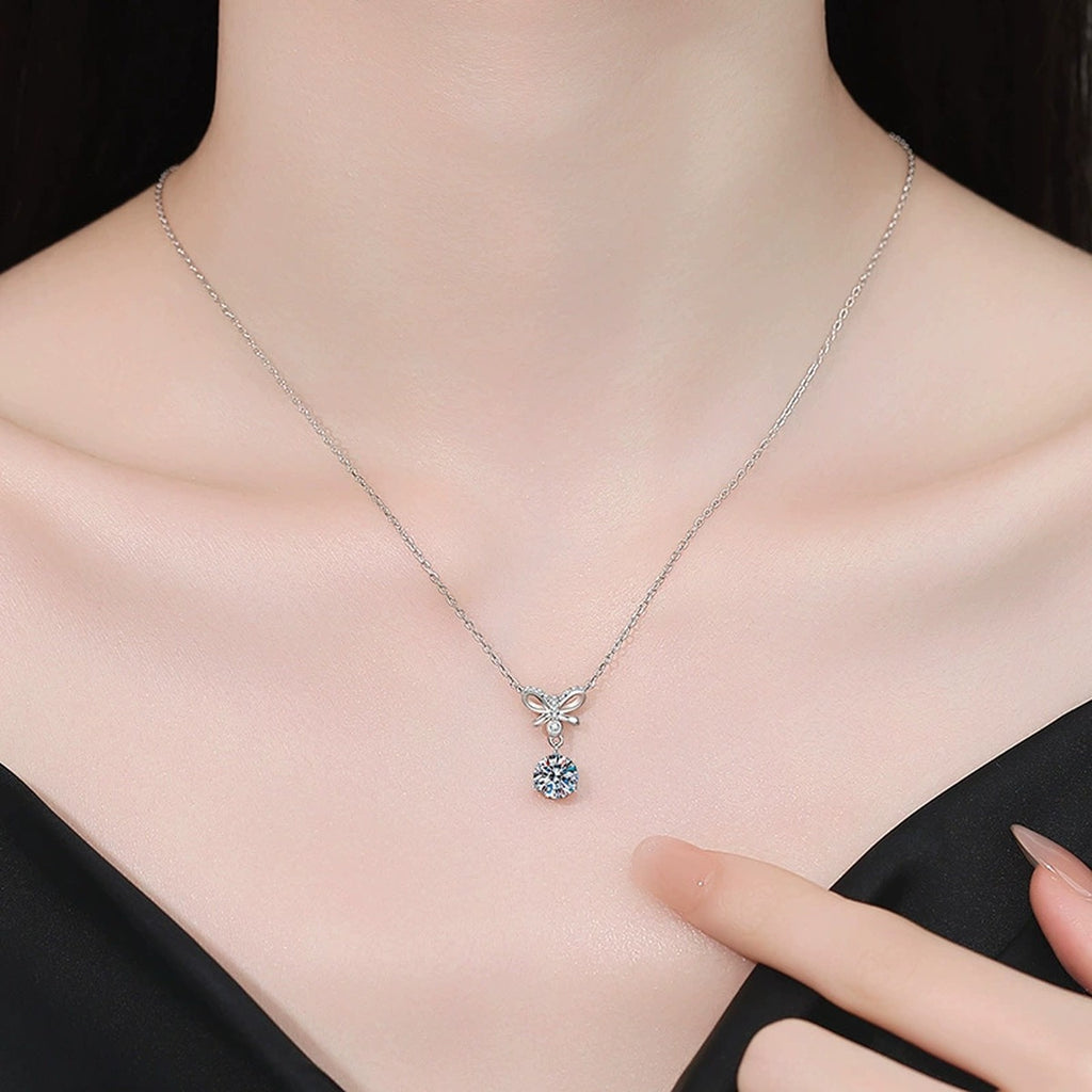 Model wearing a platinum-plated S925 sterling silver bow moissanite pendant necklace