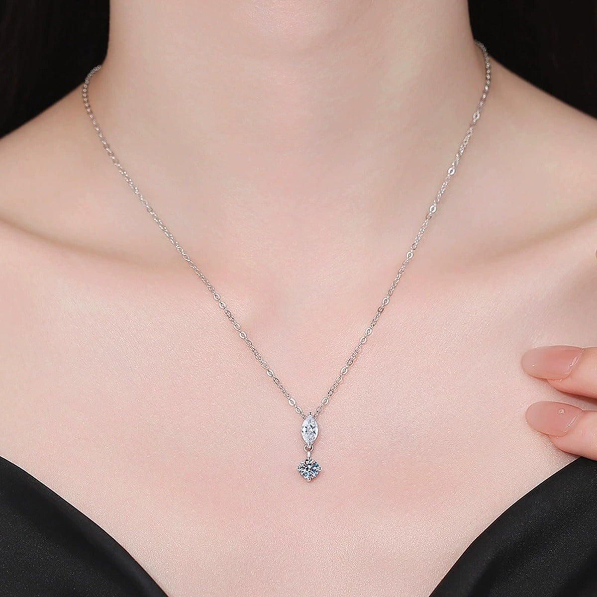 Model wearing a platinum-plated S925 sterling silver marquise and round moissanite pendant necklace
