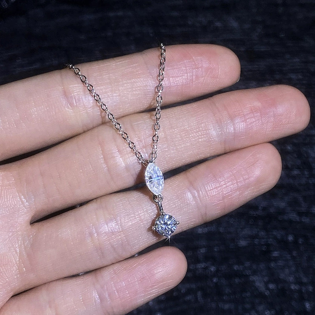 Marquise and round moissanite pendant necklace shown in hand