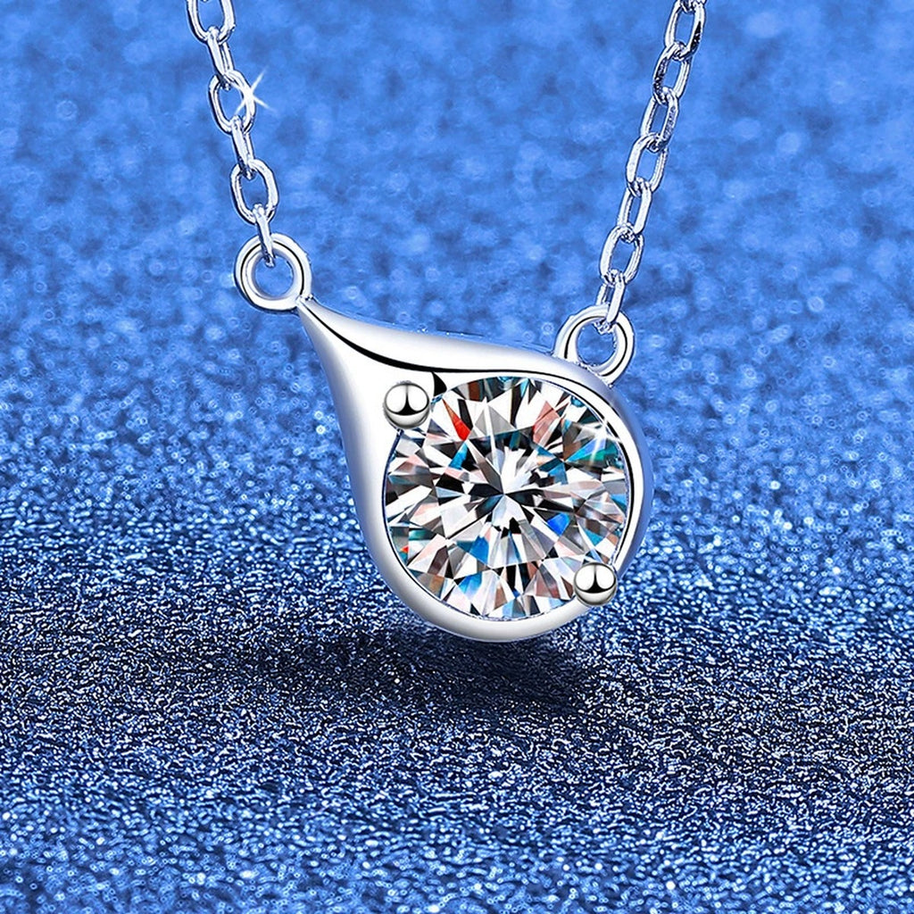 Swirl round moissanite pendant necklace on blue textured background