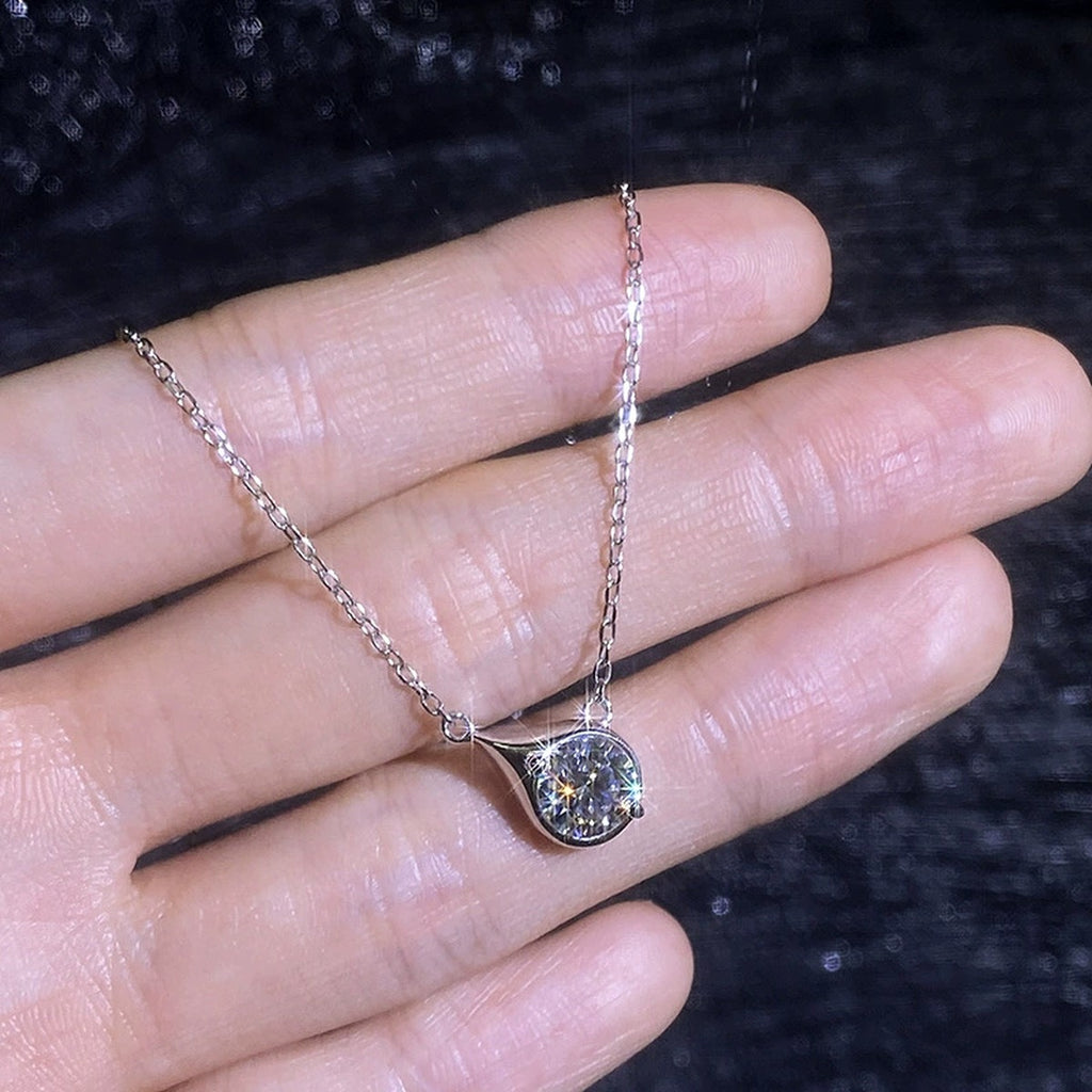 Swirl moissanite pendant necklace shown in hand