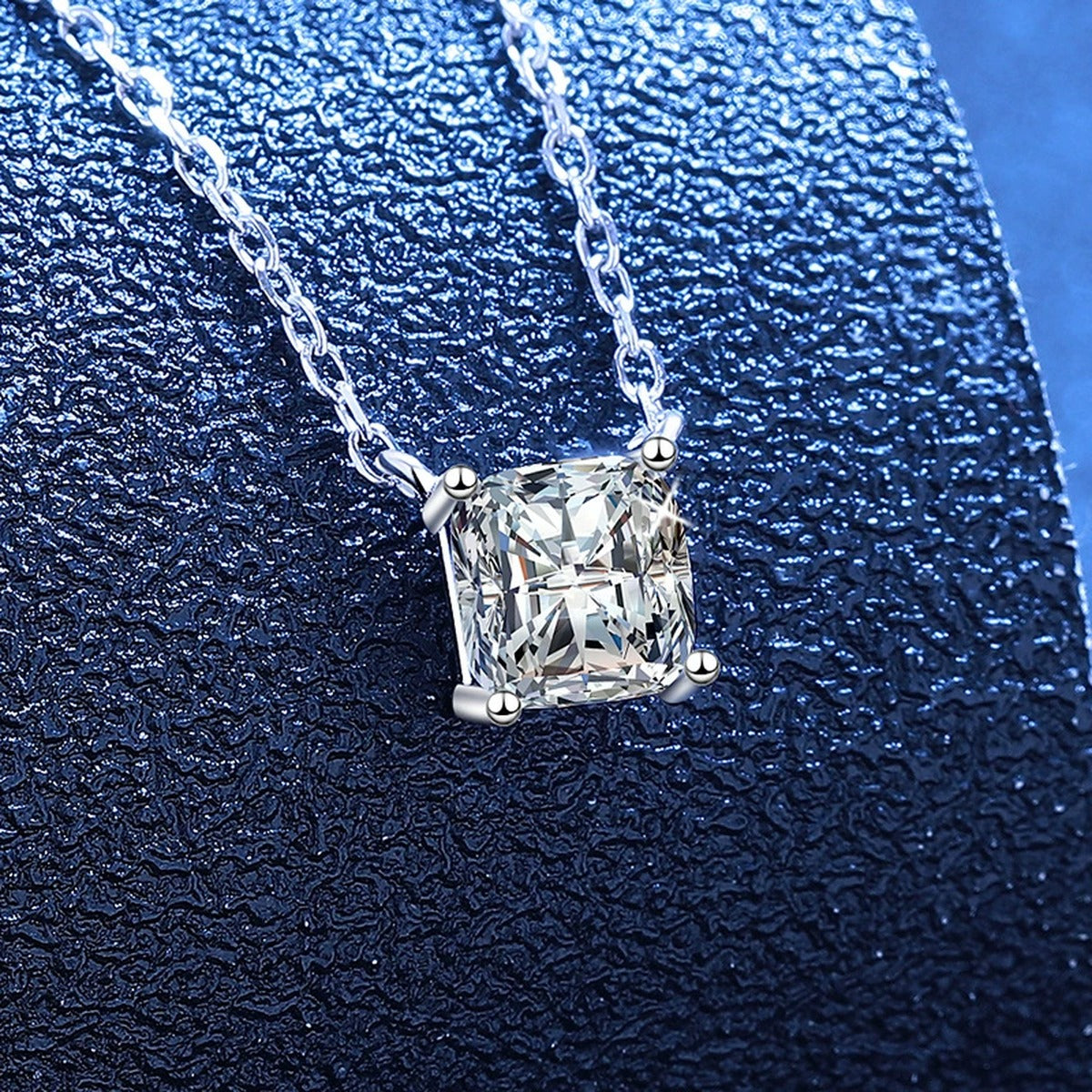 Princess Moissanite Pendant Necklace in White Gold-Plated S925 Sterling Silver blue background angled view