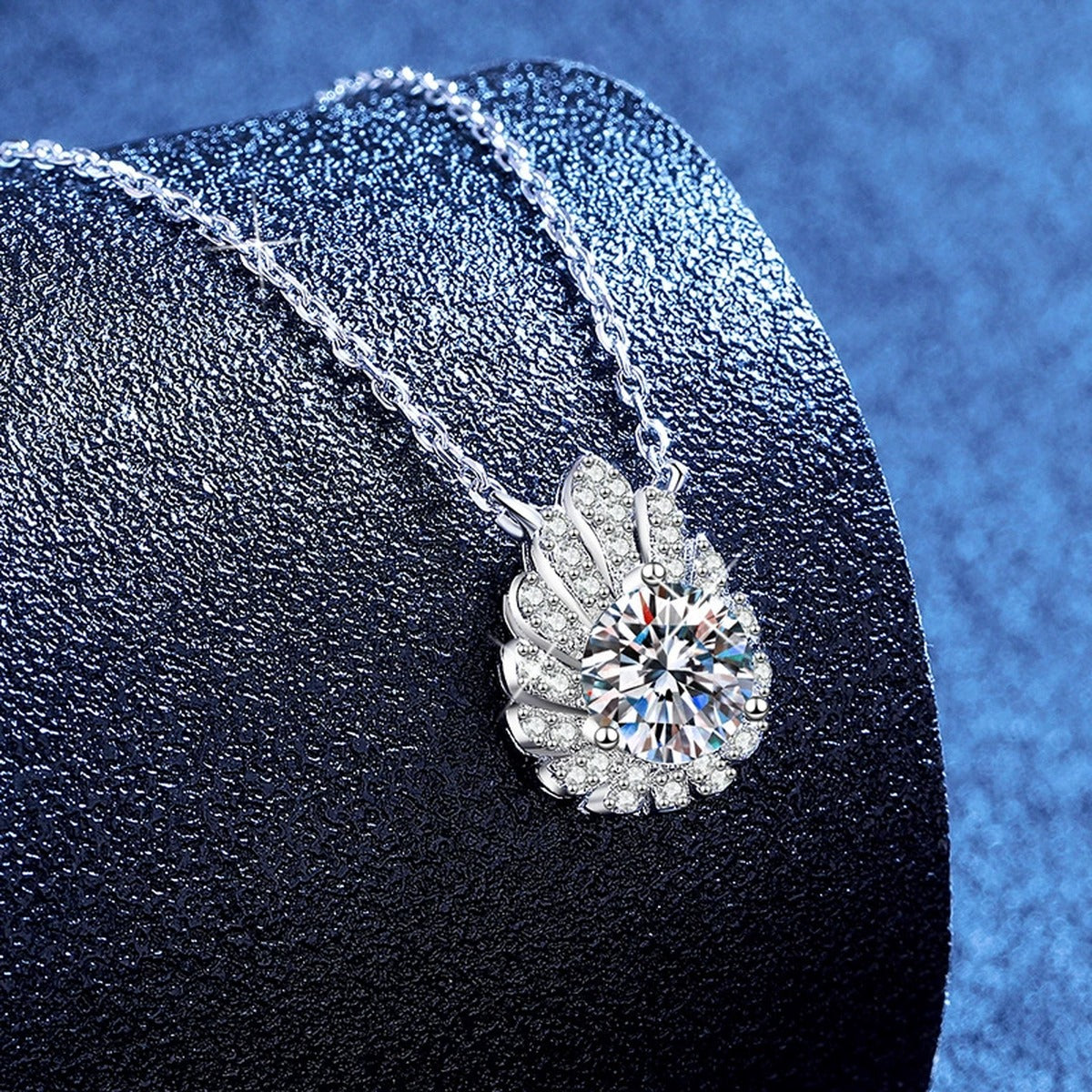Floral Moissanite Pendant Necklace with Cubic Zirconia in White Gold-Plated S925 Sterling Silver blue background angled view