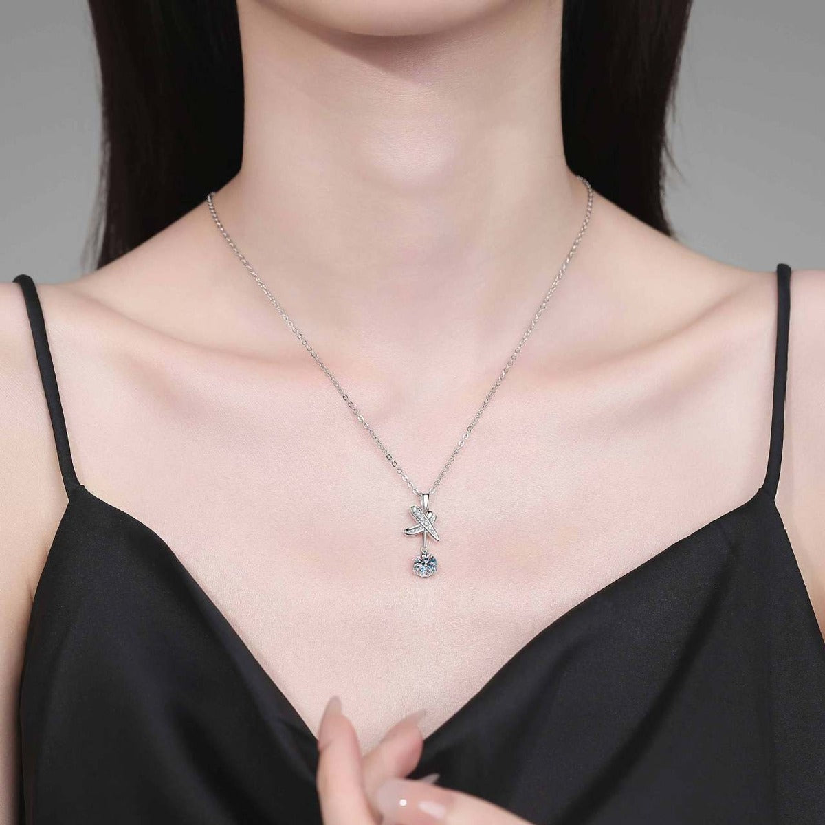 Model wearing a platinum-plated S925 sterling silver dragonfly moissanite pendant necklace