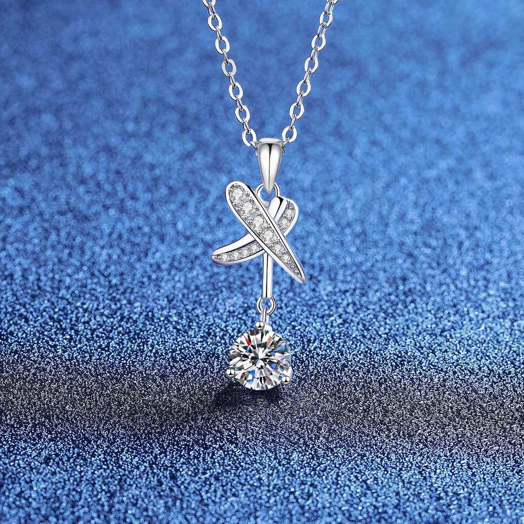 Dragonfly round moissanite pendant necklace with pavé accents on blue textured background