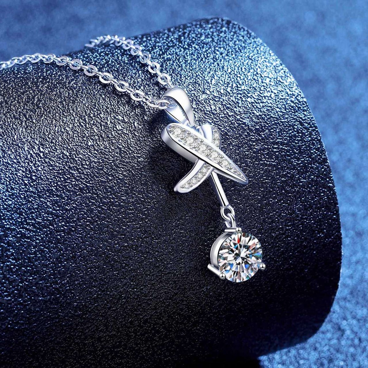 Detailed view of a dragonfly moissanite pendant necklace in platinum-plated S925 silver