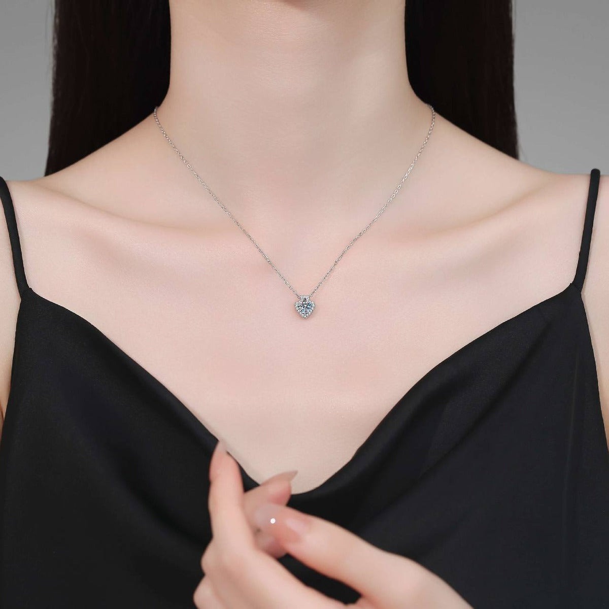 Model wearing a platinum-plated S925 sterling silver heart moissanite pendant necklace