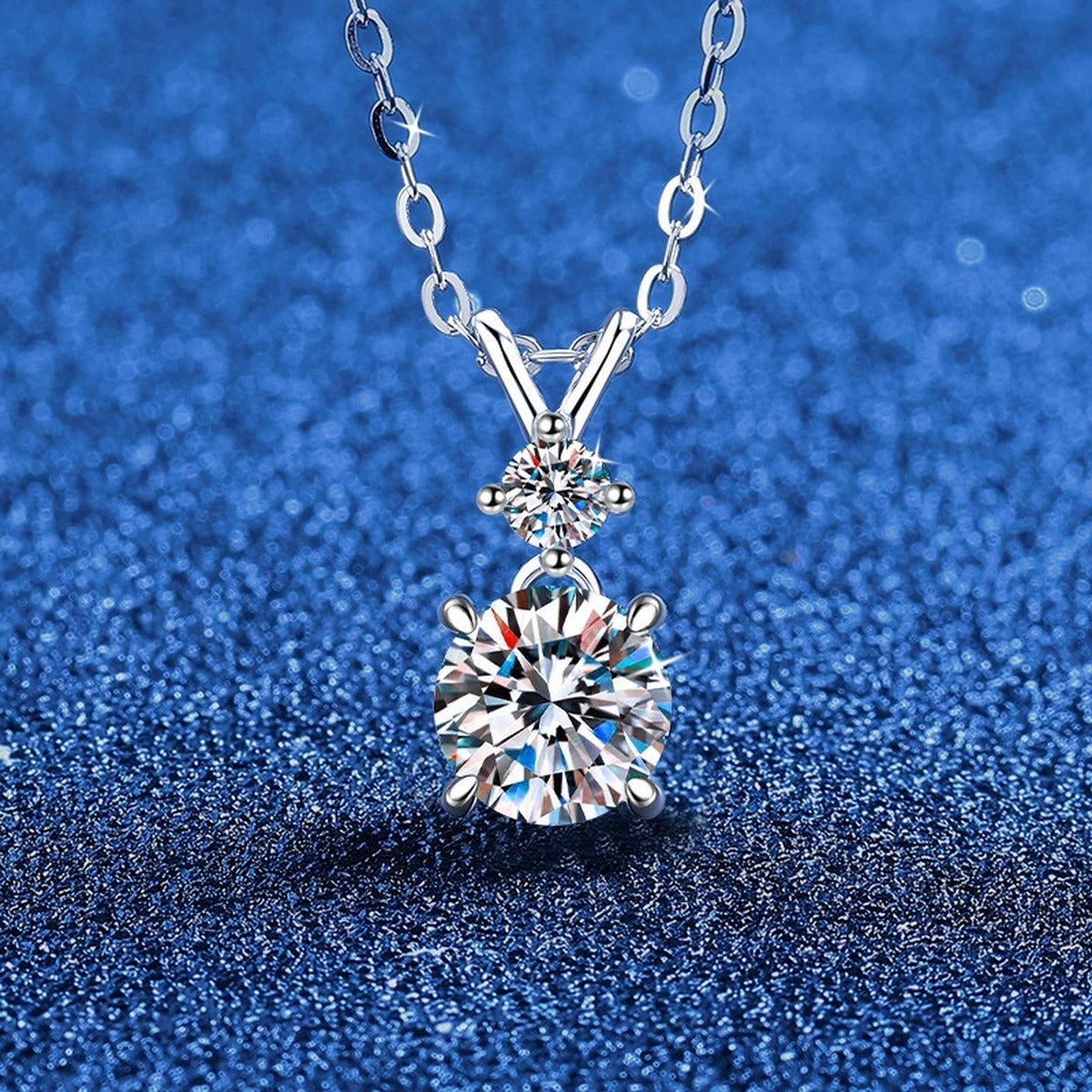 Two-Stone Moissanite Pendant Necklace in S925 Sterling Silver blue background angled view