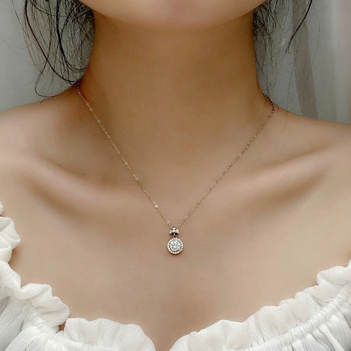 Bowknot Halo Round Moissanite Necklace with CZ in White Gold-Plated S925 sterling silver neckline model view showing pendant scale and chain length