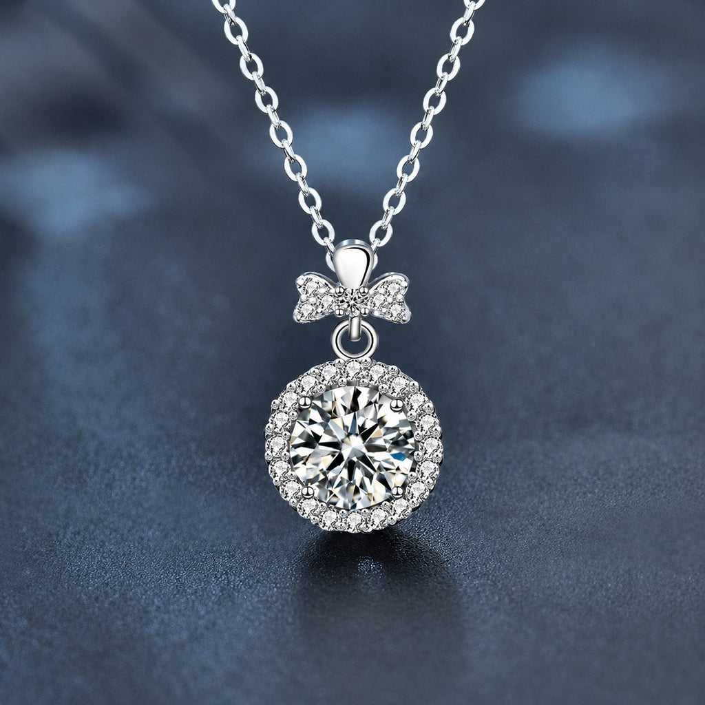 Bowknot Halo Round Moissanite Necklace with CZ in White Gold-Plated S925 sterling silver close-up styled product scene showing pendant setting