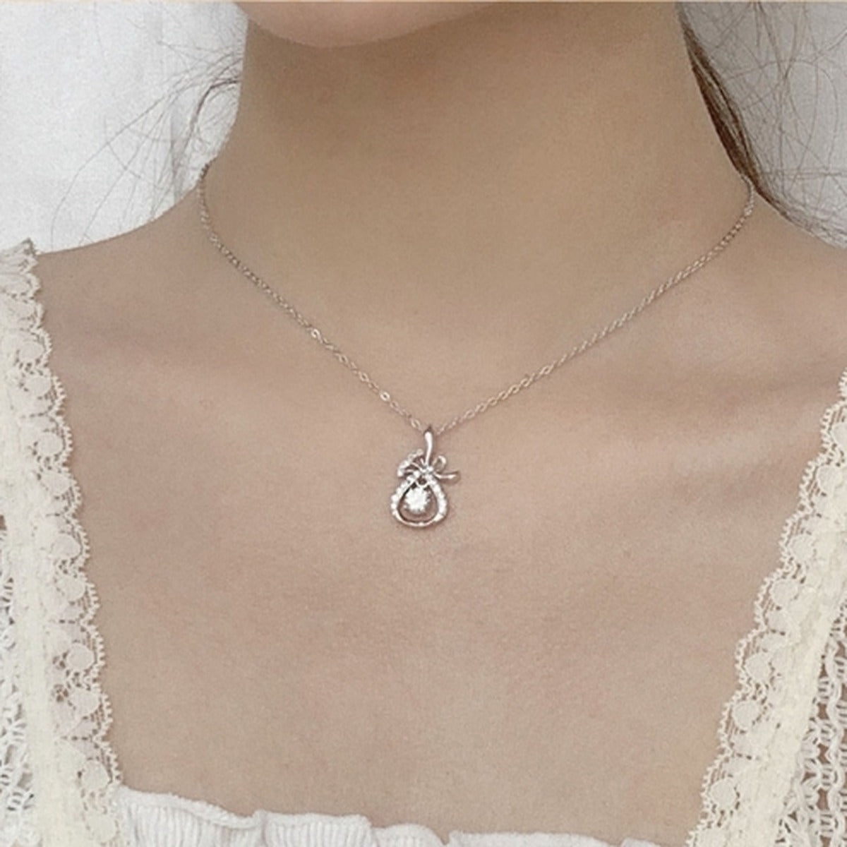 Magic Bag Round Moissanite Necklace with CZ in White Gold-Plated S925 sterling silver neckline model view showing pendant scale and chain length