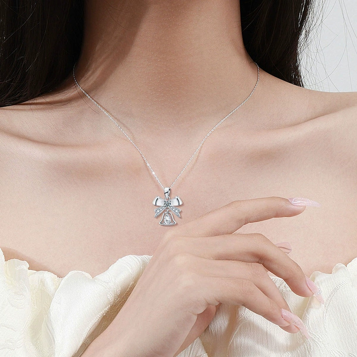 Bowknot Bell Pear Cut Moissanite Necklace with CZ in White Gold-Plated S925 sterling silver neckline model view showing pendant scale and chain length