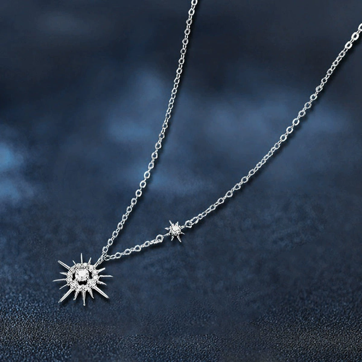 Sunburst Round Moissanite Necklace with CZ in White Gold-Plated S925 sterling silver blue display scene showing chain and stone layout
