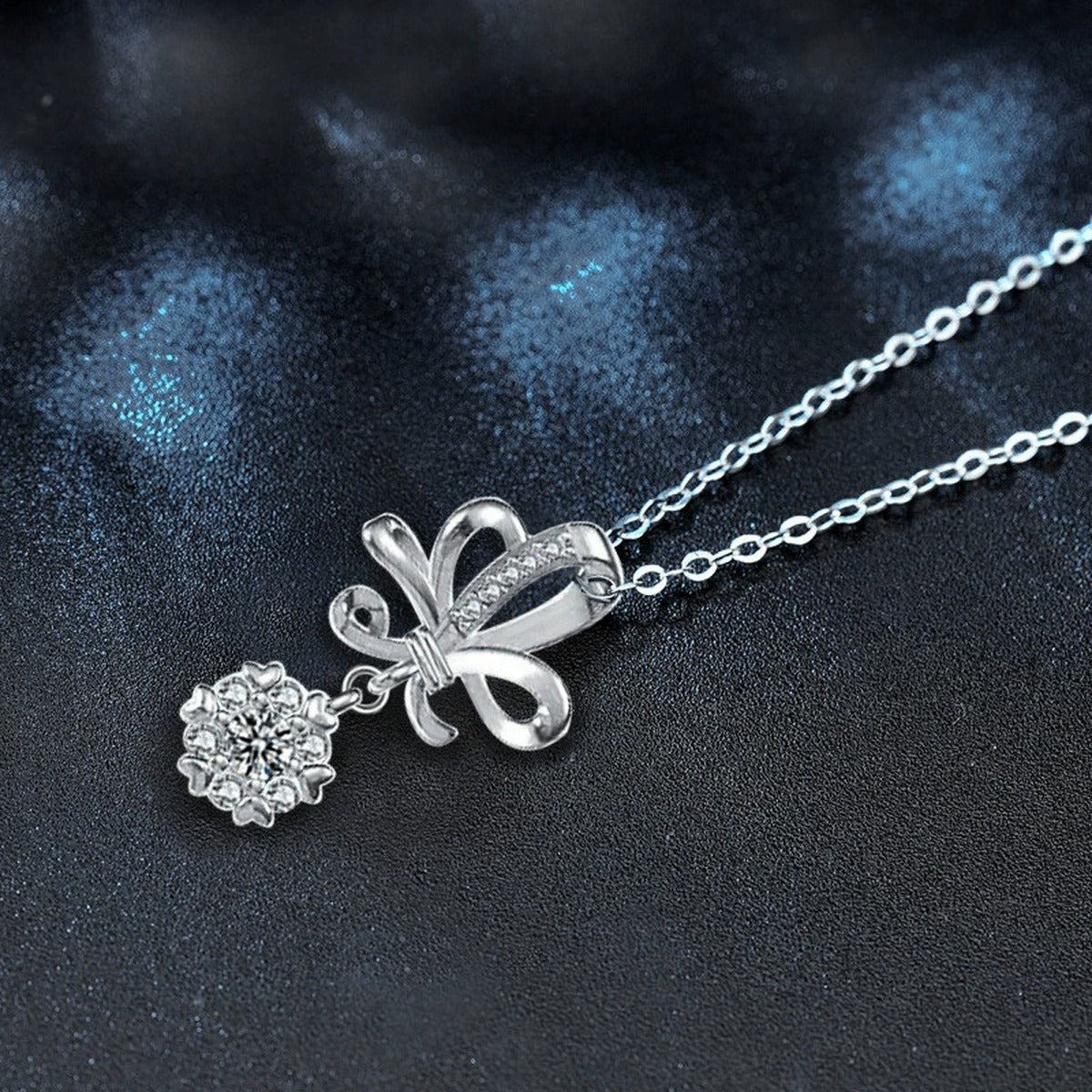Bowknot Round Moissanite Necklace with CZ in White Gold-Plated S925 sterling silver blue display scene showing chain and stone layout