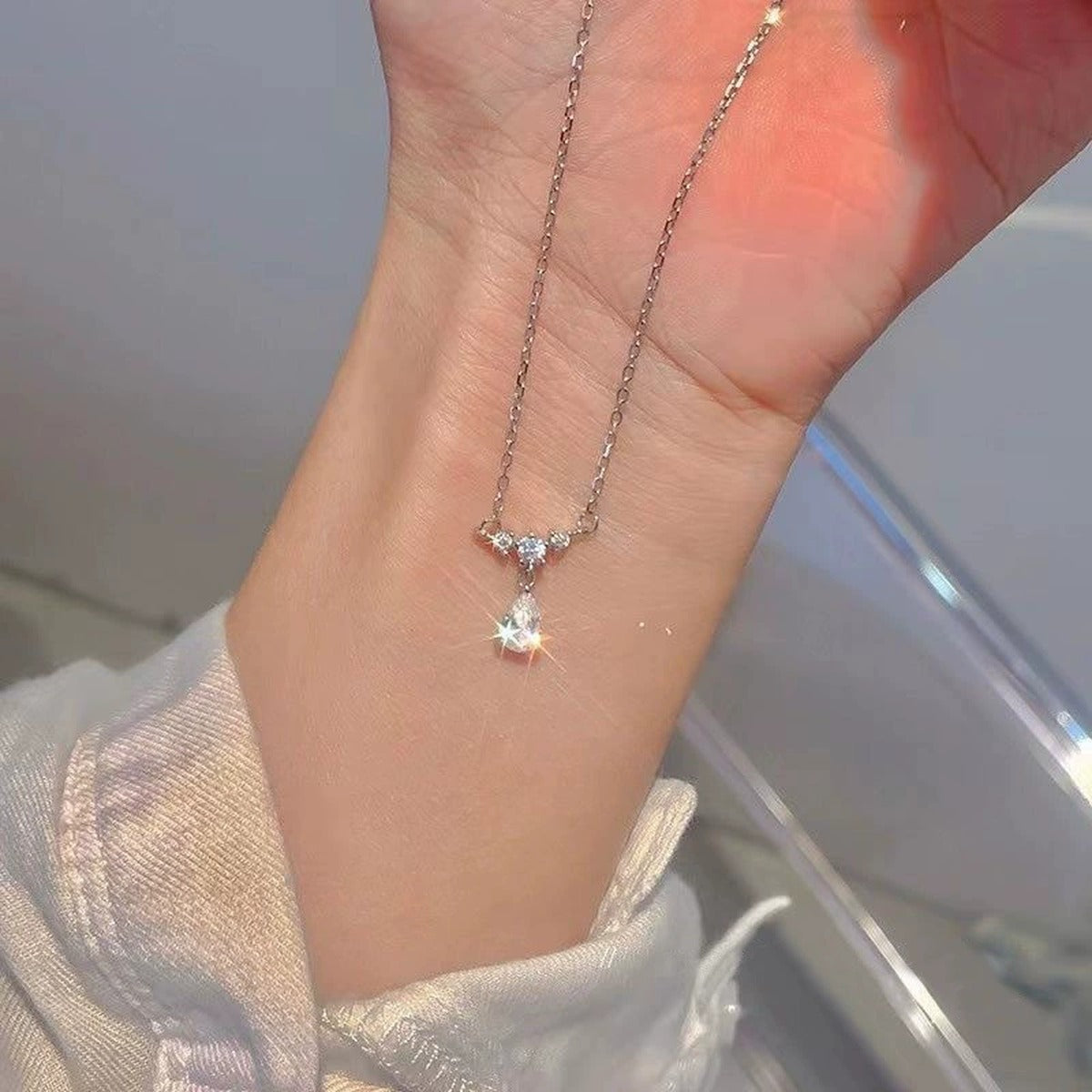 Pear Cut Teardrop Moissanite Necklace with CZ in White Gold-Plated S925 sterling silver additional worn styling view showing the pendant on the body