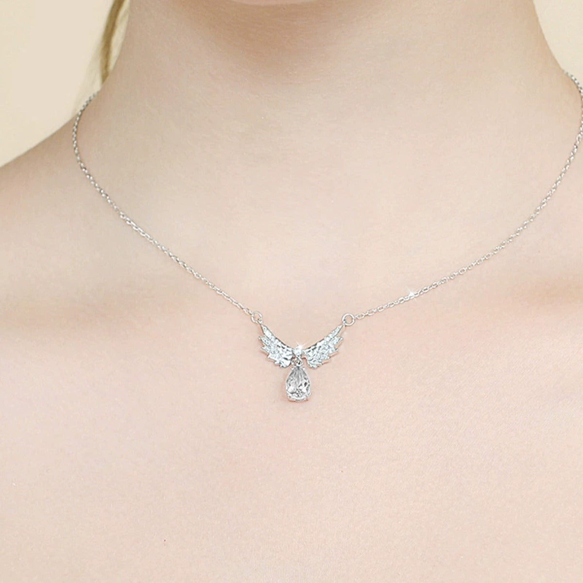 Angel Wing Pear Cut Moissanite Necklace with CZ in White Gold-Plated S925 sterling silver neckline model view showing pendant scale and chain length