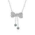 Bowknot Tassel Moissanite Necklace with CZ in White Gold-Plated S925 sterling silver white background product photo showing bowknot pendant with tassel drop and small round moissanite accents