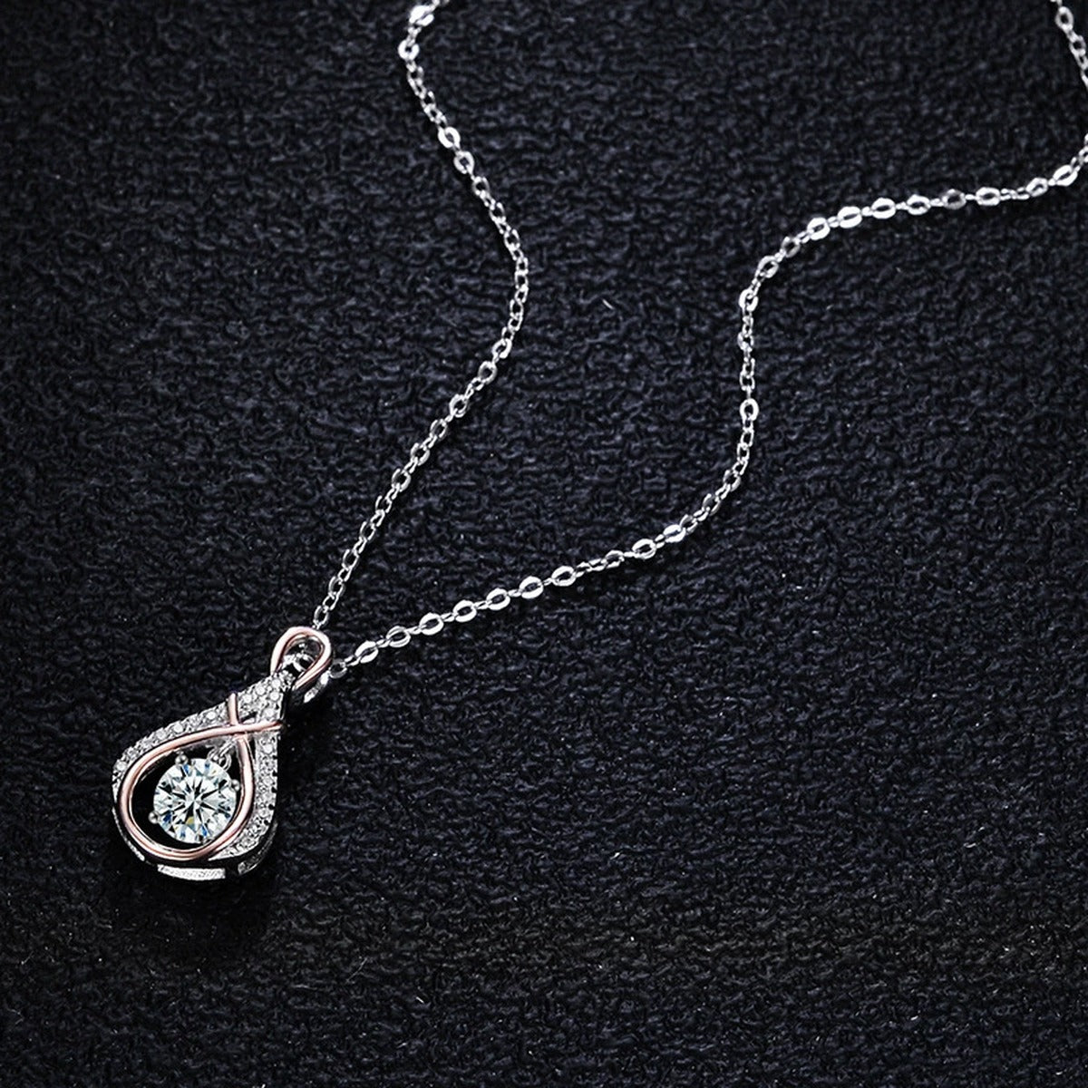 Two-Tone Dancing Round Moissanite Teardrop Necklace with CZ in S925 sterling silver close-up styled product scene showing pendant setting