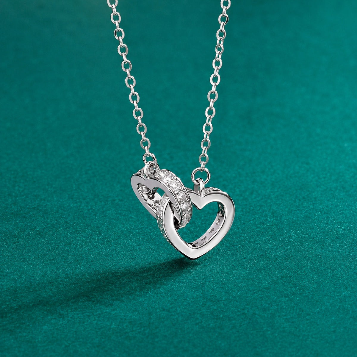Interlocking Heart Moissanite Necklace in White Gold-Plated S925 sterling silver close-up styled product scene showing pendant setting