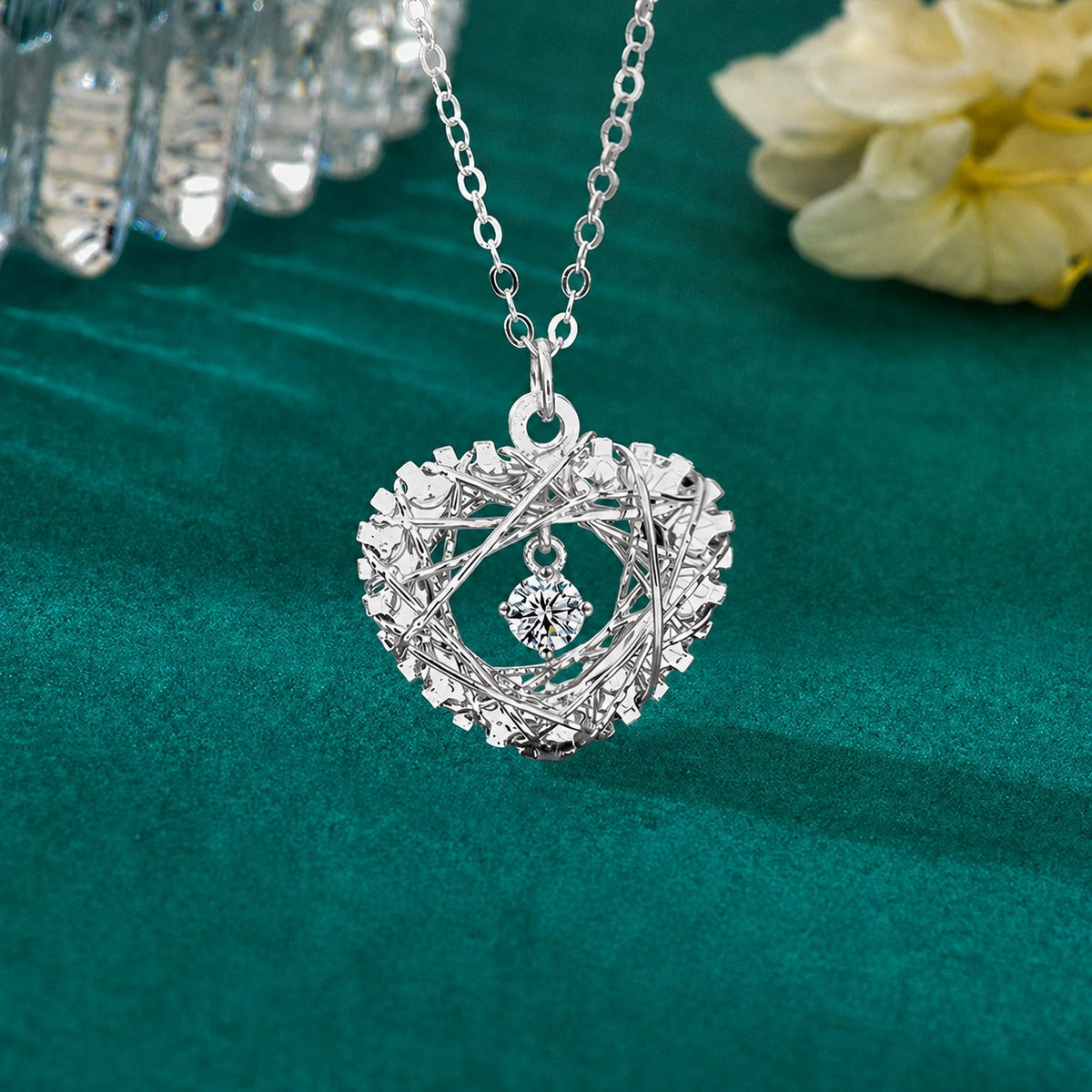 Heart Nest Dancing Round Moissanite Necklace in Gold-Plated S925 sterling silver close-up styled product scene showing pendant setting