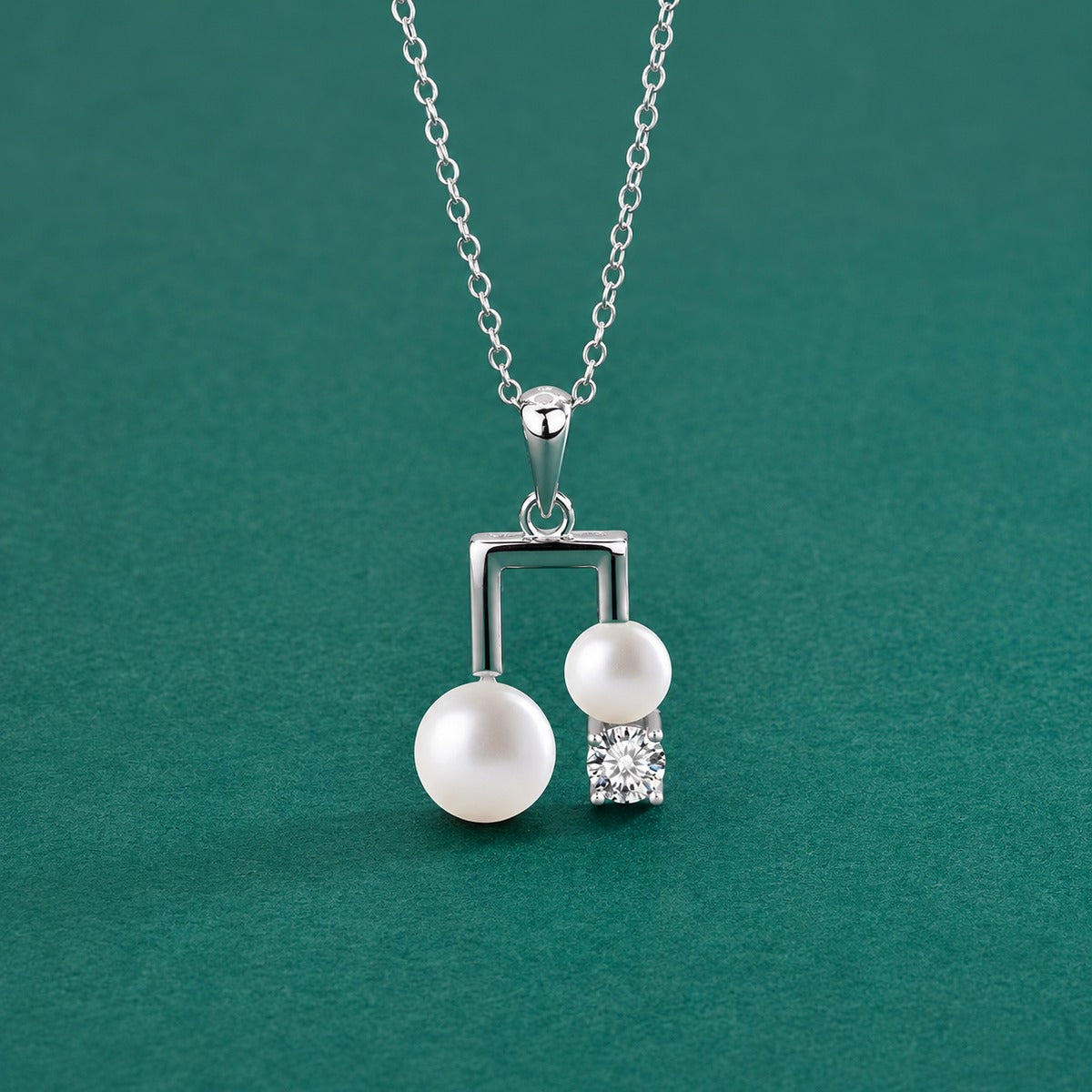 Musical Note Pearl Round Moissanite Necklace in White Gold-Plated S925 sterling silver close-up styled product scene showing pendant setting