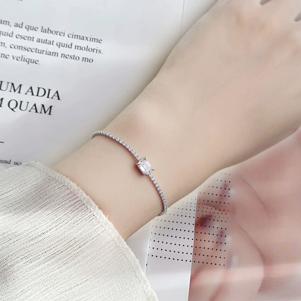 Emerald-Cut Moissanite Tennis Bracelet with CZ in White Gold-Plated S925 sterling silver worn on wrist model view showing scale and adjustable fit