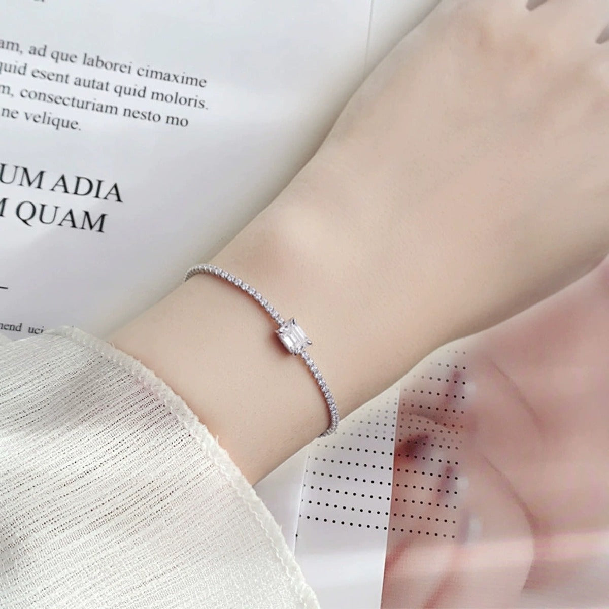 Emerald-Cut Moissanite Tennis Bracelet with CZ in White Gold-Plated S925 sterling silver worn on wrist model view showing scale and adjustable fit