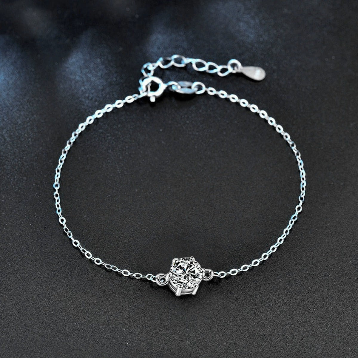 Four or Six-Prong Round Moissanite Solitaire Adjustable Bracelet in White Gold-Plated S925 Sterling Silver product detail view showing the moissanite setting, chain, and polished finish