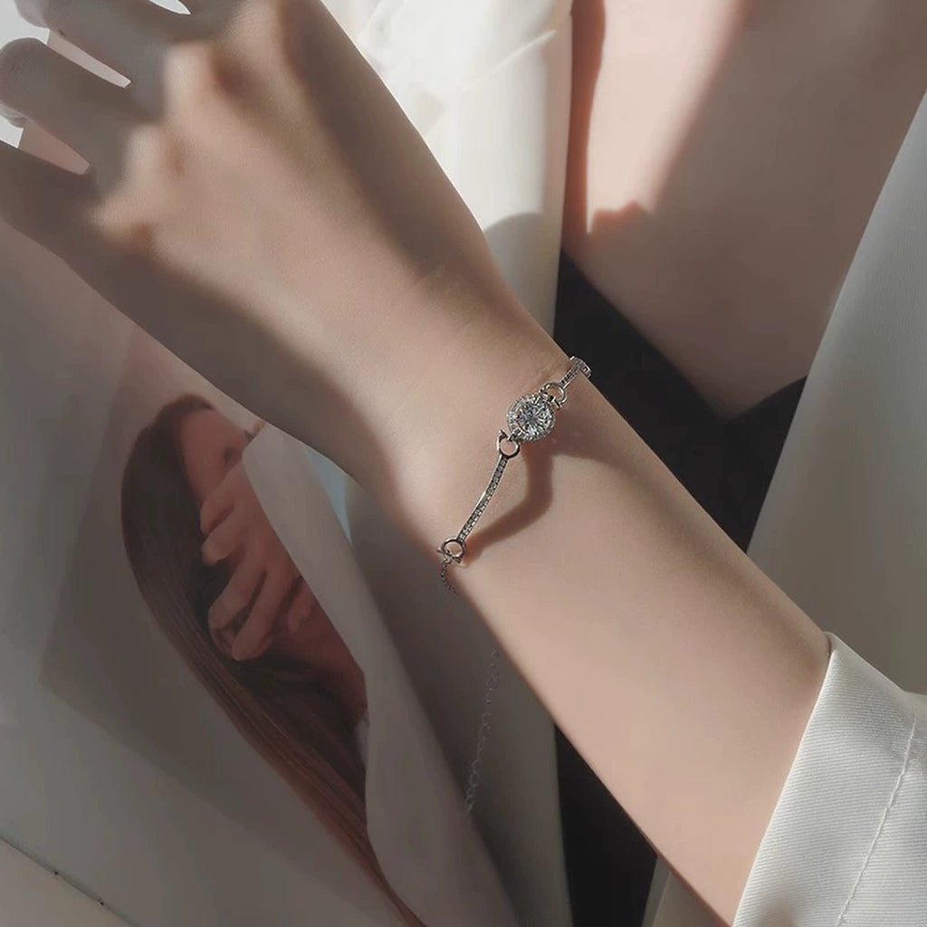 Round Halo Moissanite Bracelet with CZ in White Gold-Plated S925 sterling silver worn on wrist model view showing scale and adjustable fit