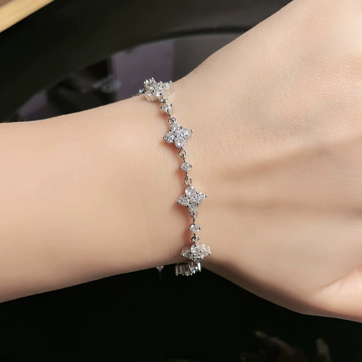 Clover Round Moissanite Charm Bracelet with CZ in Gold-Plated S925 sterling silver worn on wrist model view showing scale and adjustable fit