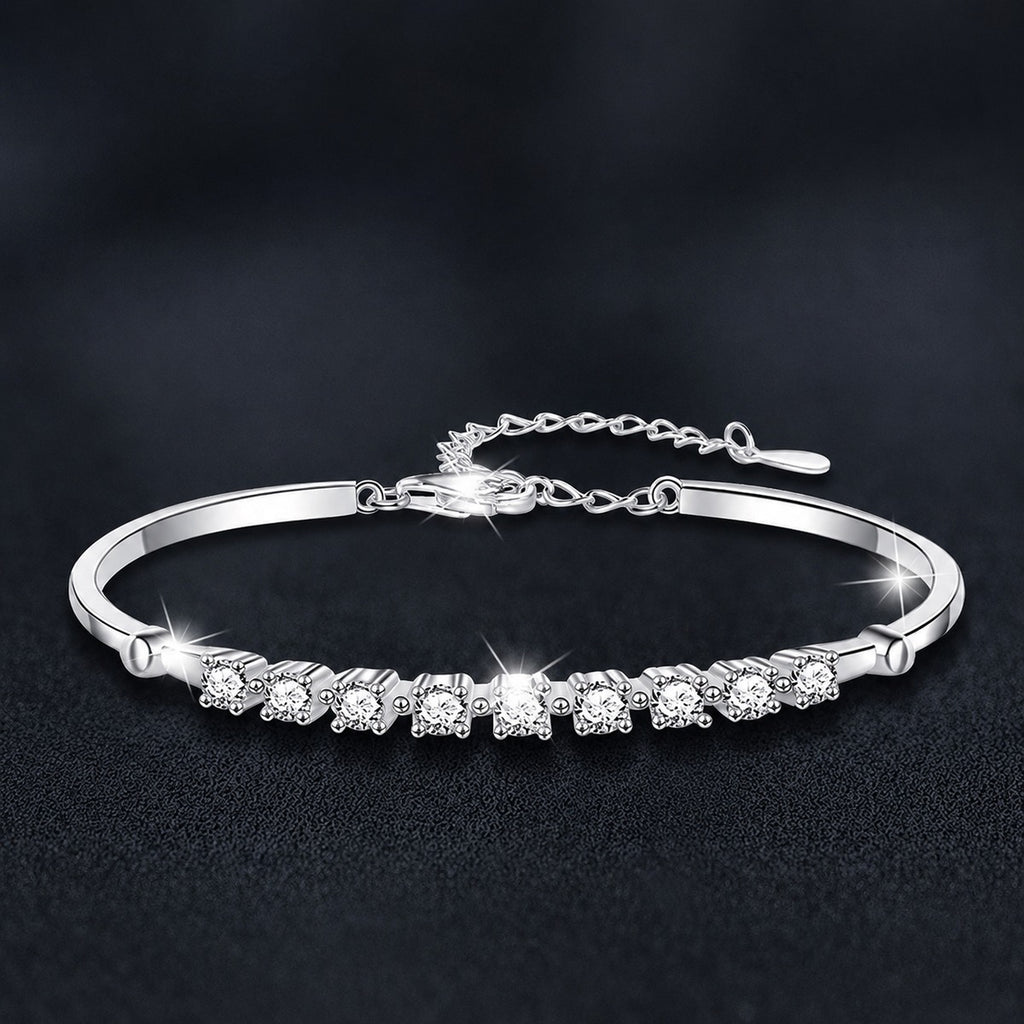 Graduated Round Moissanite Bangle Bracelet in White Gold-Plated S925 sterling silver styled product scene showing stone sparkle and chain detail