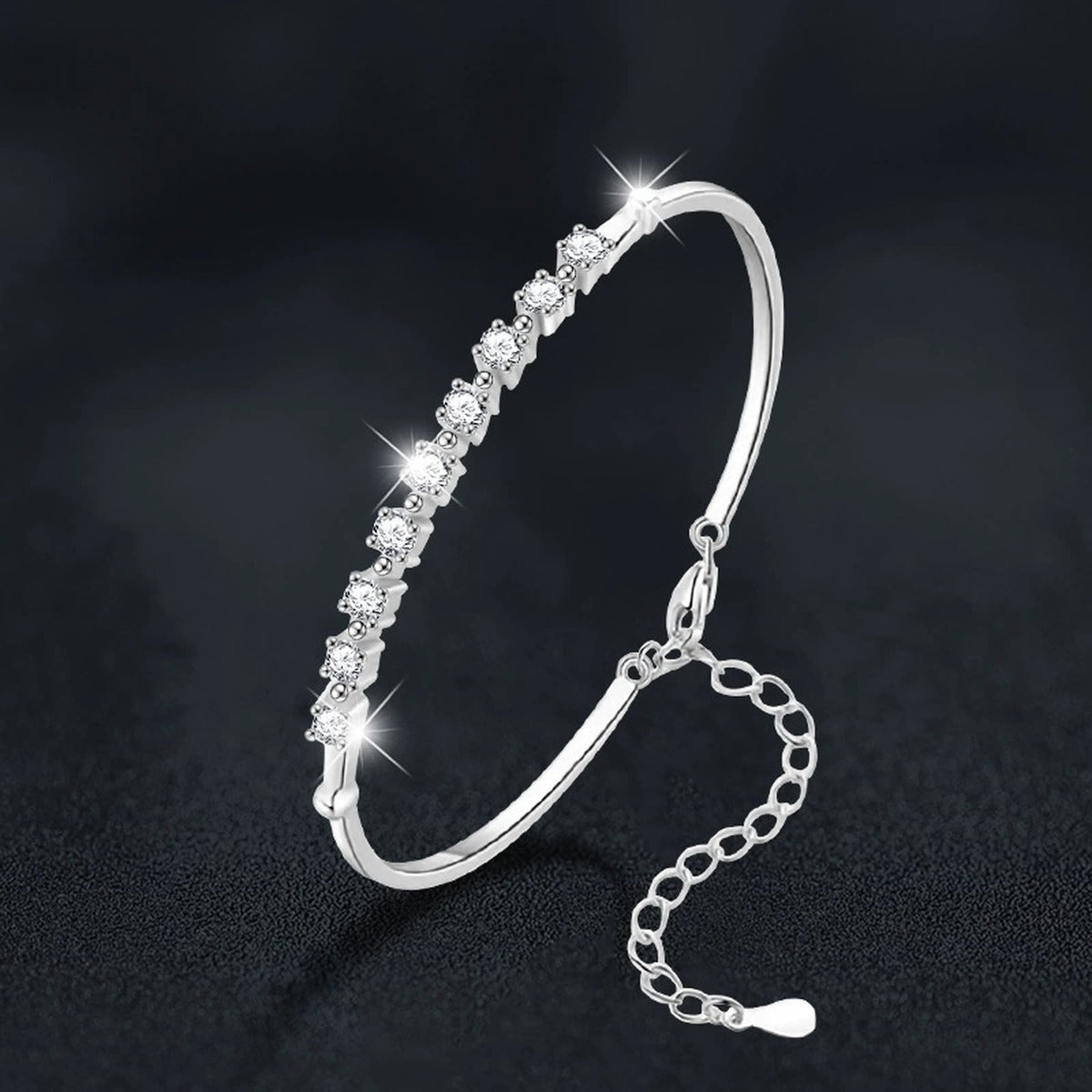 Graduated Round Moissanite Bangle Bracelet in White Gold-Plated S925 sterling silver close-up bracelet detail view showing clasp and motif