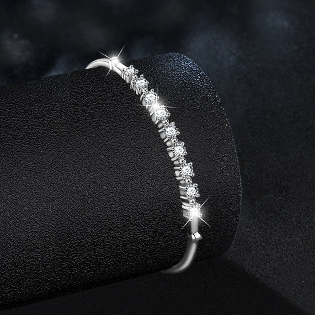 Graduated Round Moissanite Bangle Bracelet in White Gold-Plated S925 sterling silver angled product display showing bracelet silhouette