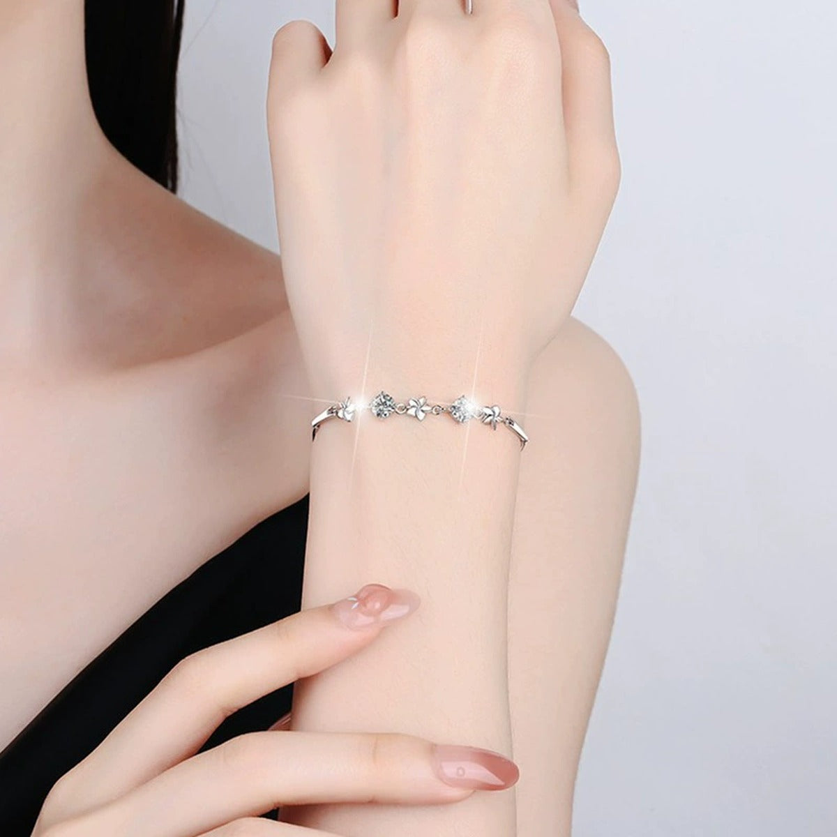 Pinwheel Round Moissanite Bracelet in White Gold-Plated S925 sterling silver worn on wrist model view showing scale and adjustable fit