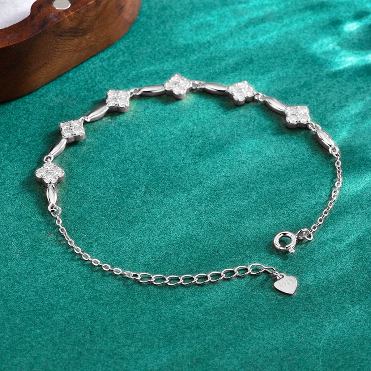 Five-Clover Round Moissanite Charm Bracelet in Gold-Plated S925 sterling silver angled product display showing bracelet silhouette